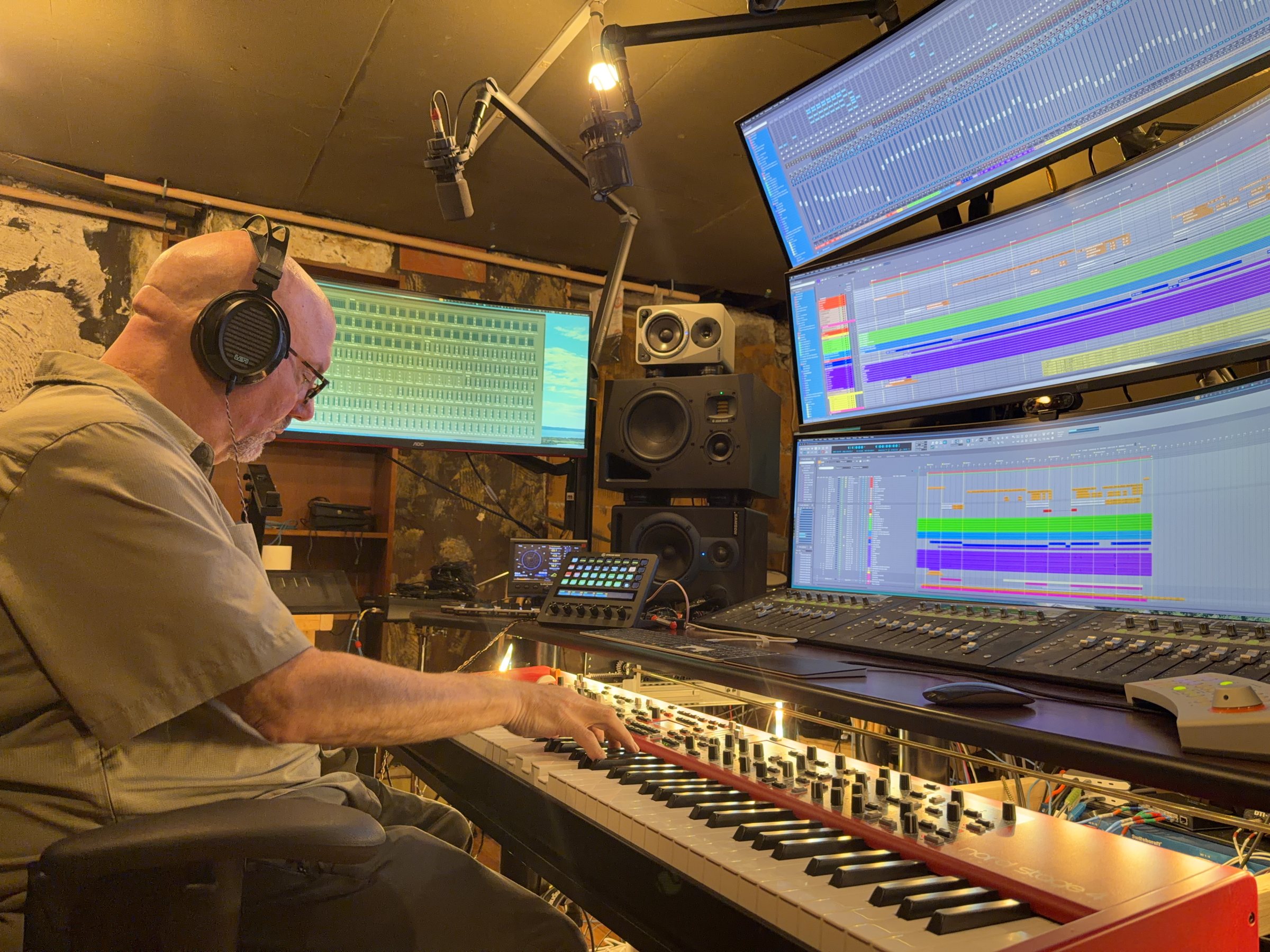 Adam Goldman playing keyboard at Audiomind's monitor workstation