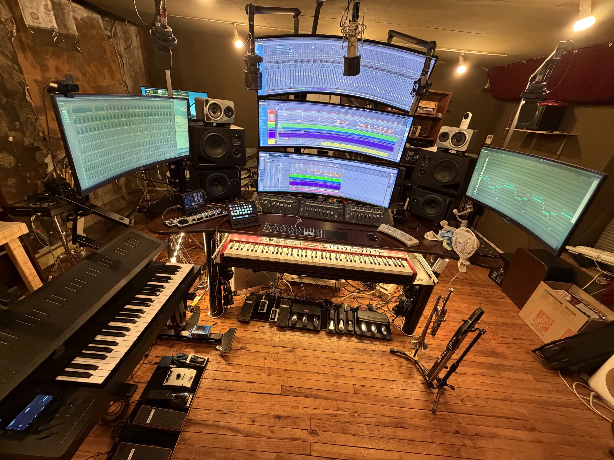 Audiomind recording studio with keyboard workstation, monitors, microphones, instruments, and recording equipment